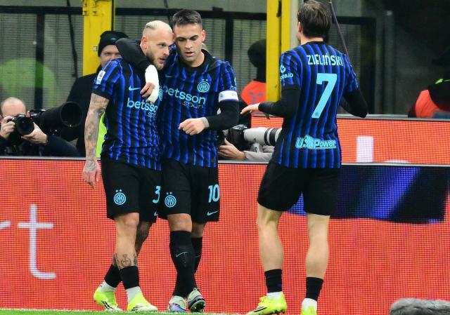 Inter Milan's Italian defender #32 Federico Dimarco (L) celebrates with Inter Milan's Argentinian forward #10 Lautaro Martinez after scoring his team's first goal during the Italian Serie A football match between Inter Milan and Napoli at San Siro stadium in Milan, on January 11, 2026. (Photo by Stefano RELLANDINI / AFP)