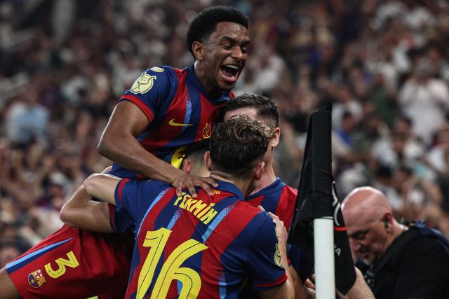 Barcelona's players celebrate after Polish forward #09 Robert Lewandowski scored his team's second goal during the Spanish Super Cup final football match between FC Barcelona and Real Madrid at the King Abdullah Stadium in Jeddah on January 11, 2026. (Photo by Fadel SENNA / AFP)