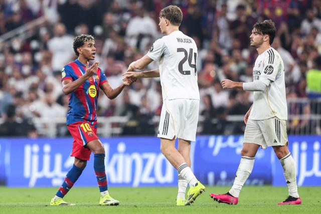 Barcelona's Spanish forward #10 Lamine Yamal (L) reacts during the Spanish Super Cup final football match between FC Barcelona and Real Madrid at the King Abdullah Stadium in Jeddah on January 11, 2026. (Photo by Haitham AL-SHUKAIRI / AFP)