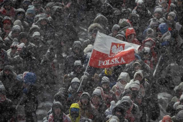 Polish fans wave a Polish flag during the Men's Large Hill HS140 event of the FIS Ski Jumping World Cup in Zakopane, Poland on January 11, 2026. (Photo by Wojtek RADWANSKI / AFP)