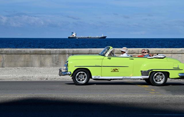 A car rides in Havana on January 11, 2026. Cuba's President Miguel Diaz-Canel rebuffed US President Donald Trump's threat against his country, vowing to defend it following Washington's capture of the leader of his ally Venezuela. (Photo by ADALBERTO ROQUE / AFP)