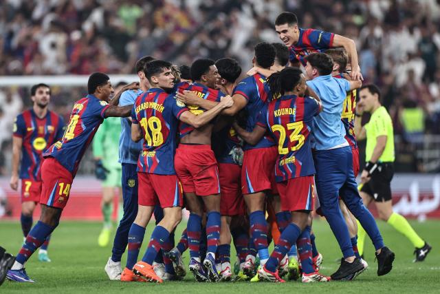 Barcelona's players celebrate after winning the Spanish Super Cup final football match between FC Barcelona and Real Madrid at the King Abdullah Stadium in Jeddah on January 11, 2026. (Photo by Fadel SENNA / AFP)