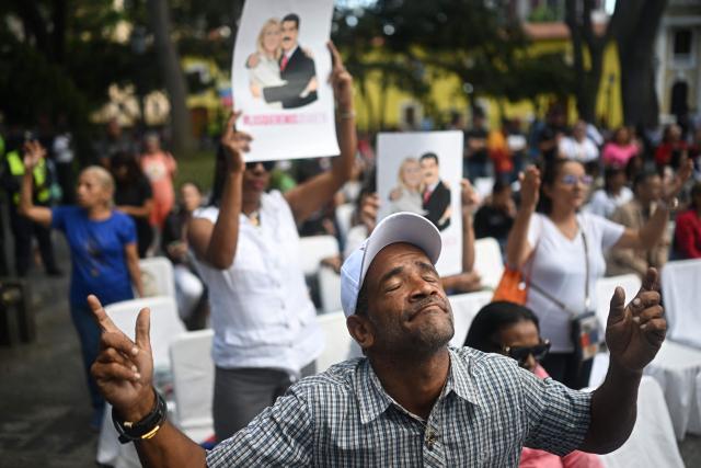 An Evangelical man prays during an event in support of deposed Venezuelan president Nicolas Maduro and his wife Cilia Flores, at Plaza Bolivar in Caracas on January 11, 2026.  (Photo by Federico PARRA / AFP)