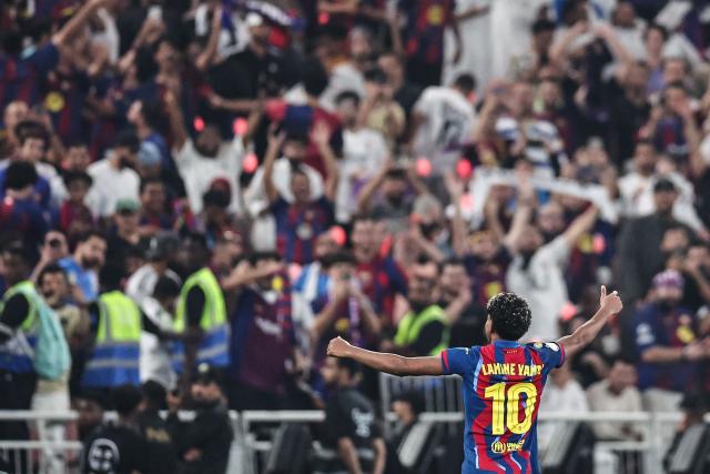 Barcelona's Spanish forward #10 Lamine Yamal celebrates after winning the Spanish Super Cup final football match between FC Barcelona and Real Madrid at the King Abdullah Stadium in Jeddah on January 11, 2026. (Photo by Fadel SENNA / AFP)