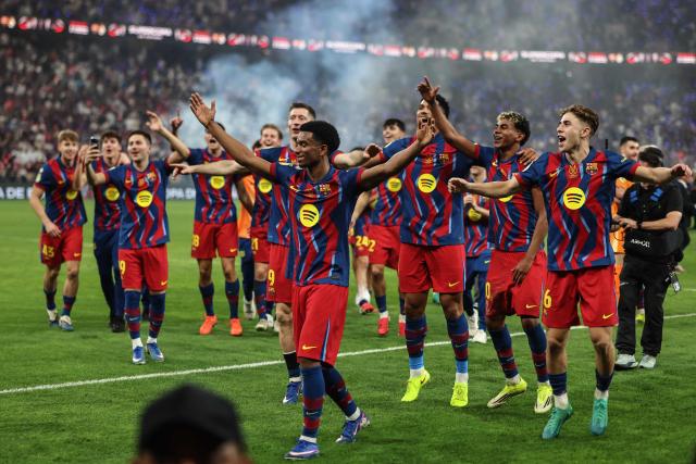 Barcelona's players celebrate after winning the Spanish Super Cup final football match between FC Barcelona and Real Madrid at the King Abdullah Stadium in Jeddah on January 11, 2026. (Photo by Fadel SENNA / AFP)