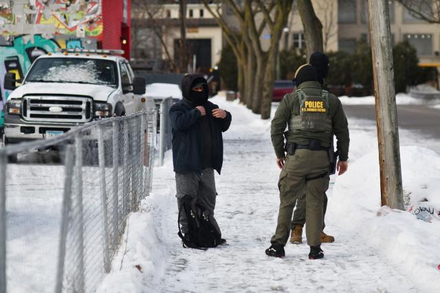 US Customs and Border Protection agents question a man asking if he’s a US citizen while patrolling a neighborhood during immigration enforcement activity in Minneapolis in Minneapolis, Minnesota, on January 11, 2026. A US Immigration and Customs Enforcement (ICE) agent shot and killed 37-year-old Renee Nicole Good on the streets of Minneapolis on January 7, leading to huge protests and outrage from local leaders who rejected White House claims she was a domestic terrorist. (Photo by Octavio JONES / AFP)