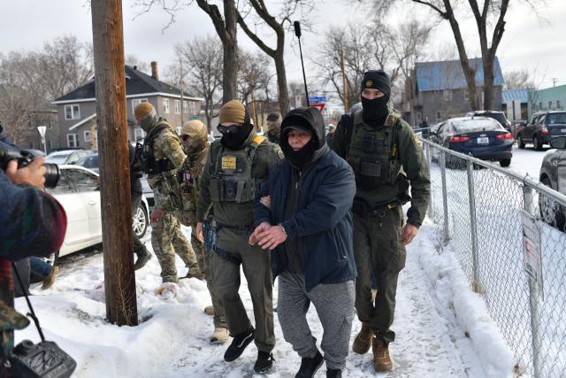US Customs and Border Protection agents arrest a man after not providing documents proving he’s a citizen of the United States while patrolling a neighborhood during immigration enforcement activity in Minneapolis in Minneapolis, Minnesota, on January 11, 2026. A US Immigration and Customs Enforcement (ICE) agent shot and killed 37-year-old Renee Nicole Good on the streets of Minneapolis on January 7, leading to huge protests and outrage from local leaders who rejected White House claims she was a domestic terrorist. (Photo by Octavio JONES / AFP)