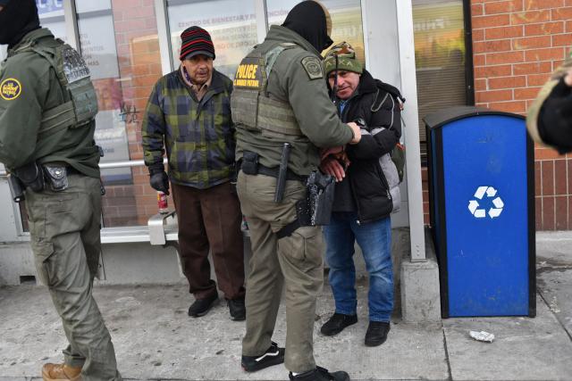 US Customs and Border Protection agents arrest a man after not providing documents proving he’s a citizen of the United States while patrolling a neighborhood during immigration enforcement activity in Minneapolis in Minneapolis, Minnesota, on January 11, 2026. A US Immigration and Customs Enforcement (ICE) agent shot and killed 37-year-old Renee Nicole Good on the streets of Minneapolis on January 7, leading to huge protests and outrage from local leaders who rejected White House claims she was a domestic terrorist. (Photo by Octavio JONES / AFP)