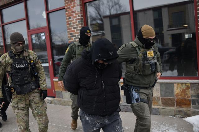 US Customs and Border Protection agents arrest a man after not providing documents proving he’s a citizen of the United States while patrolling a neighborhood during immigration enforcement activity in Minneapolis in Minneapolis, Minnesota, on January 11, 2026. A US Immigration and Customs Enforcement (ICE) agent shot and killed 37-year-old Renee Nicole Good on the streets of Minneapolis on January 7, leading to huge protests and outrage from local leaders who rejected White House claims she was a domestic terrorist. (Photo by Octavio JONES / AFP)