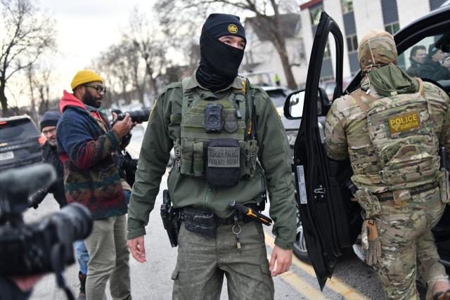 US Customs and Border Protection agents patrol a neighborhood during immigration enforcement activity in Minneapolis in Minneapolis, Minnesota, on January 11, 2026. A US Immigration and Customs Enforcement (ICE) agent shot and killed 37-year-old Renee Nicole Good on the streets of Minneapolis on January 7, leading to huge protests and outrage from local leaders who rejected White House claims she was a domestic terrorist. (Photo by Octavio JONES / AFP)