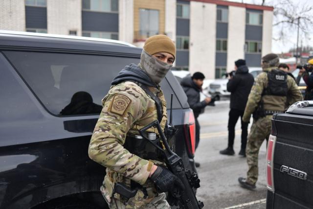 US Customs and Border Protection agents prepare to leave a neighborhood after arresting a man after not providing documents proving hes a citizen of the United States while patrolling a neighborhood during immigration enforcement activity in Minneapolis in Minneapolis, Minnesota, on January 11, 2026. A US Immigration and Customs Enforcement (ICE) agent shot and killed 37-year-old Renee Nicole Good on the streets of Minneapolis on January 7, leading to huge protests and outrage from local leaders who rejected White House claims she was a domestic terrorist. (Photo by Octavio JONES / AFP)