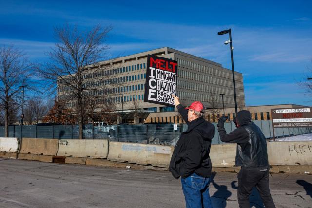 A protester holds a sign reading “Melt ICE” outside the Whipple Building, an ICE facility in Minneapolis, Minnesota, on January 11, 2026. A US Immigration and Customs Enforcement (ICE) agent shot and killed 37-year-old Renee Nicole Good on the streets of Minneapolis on January 7, leading to huge protests and outrage from local leaders who rejected White House claims she was a domestic terrorist. (Photo by Kerem YUCEL / AFP)
