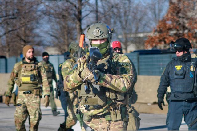 US Customs and Border Protection agents patrol a neighborhood during immigration enforcement activity in Minneapolis in Minneapolis, Minnesota, on January 11, 2026. A US Immigration and Customs Enforcement (ICE) agent shot and killed 37-year-old Renee Nicole Good on the streets of Minneapolis on January 7, leading to huge protests and outrage from local leaders who rejected White House claims she was a domestic terrorist. (Photo by Kerem YUCEL / AFP)