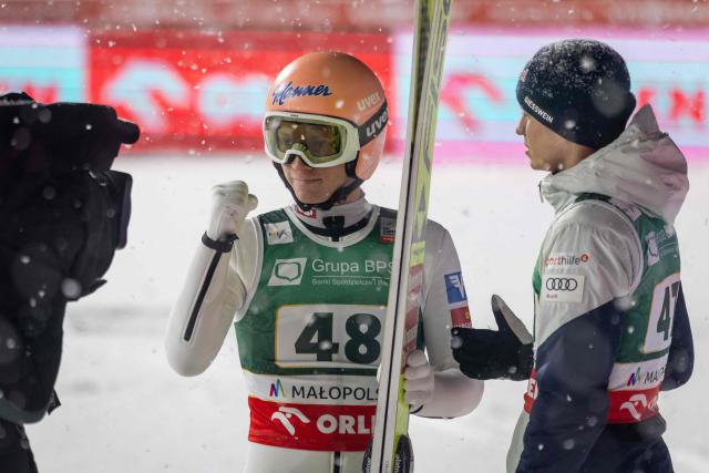 Second placed Austria's Jan Hoerl (C) celebrates after the Men's Large Hill HS140 event of the FIS Ski Jumping World Cup in Zakopane, Poland on January 11, 2026. Slovenia's Anze Lanisek won the event ahead of Austria's Jan Hoerl and Austria's Manuel Fettner. (Photo by Wojtek RADWANSKI / AFP)