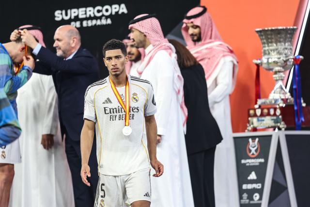 Real Madrid's English midfielder #05 Jude Bellingham receives the silver medal after his team lost the Spanish Super Cup final football match against FC Barcelona at the King Abdullah Stadium in Jeddah on January 11, 2026. (Photo by Haitham AL-SHUKAIRI / AFP)