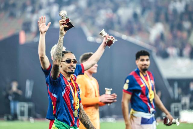 Barcelona's Brazilian forward #11 Raphinha celebrates after winning the Spanish Super Cup final football match between FC Barcelona and Real Madrid at the King Abdullah Stadium in Jeddah on January 11, 2026. (Photo by Haitham AL-SHUKAIRI / AFP)