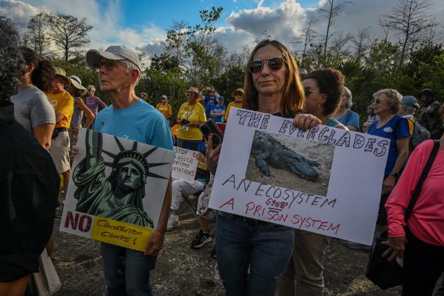 Demonstrators protest against Immigration and Customs Enforcement (ICE) and demanding the closure of the immigrant detention center known as "Alligator Alcatraz" outside the center at the Dade-Collier Training and Transition Airport in Ochopee, Florida, on January 11, 2026. A US Immigration and Customs Enforcement (ICE) agent shot and killed 37-year-old Renee Nicole Good on the streets of Minneapolis on January 7, leading to huge protests and outrage from local leaders who rejected White House claims she was a domestic terrorist. (Photo by Giorgio VIERA / AFP)