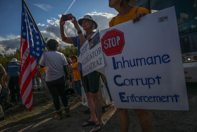 Demonstrators protest against Immigration and Customs Enforcement (ICE) and demanding the closure of the immigrant detention center known as "Alligator Alcatraz" outside the center at the Dade-Collier Training and Transition Airport in Ochopee, Florida, on January 11, 2026. A US Immigration and Customs Enforcement (ICE) agent shot and killed 37-year-old Renee Nicole Good on the streets of Minneapolis on January 7, leading to huge protests and outrage from local leaders who rejected White House claims she was a domestic terrorist. (Photo by Giorgio VIERA / AFP)