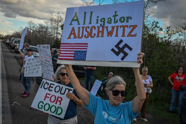 Demonstrators protest against Immigration and Customs Enforcement (ICE) and demanding the closure of the immigrant detention center known as "Alligator Alcatraz" outside the center at the Dade-Collier Training and Transition Airport in Ochopee, Florida, on January 11, 2026. A US Immigration and Customs Enforcement (ICE) agent shot and killed 37-year-old Renee Nicole Good on the streets of Minneapolis on January 7, leading to huge protests and outrage from local leaders who rejected White House claims she was a domestic terrorist. (Photo by Giorgio VIERA / AFP)
