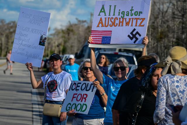 Demonstrators protest against Immigration and Customs Enforcement (ICE) and demanding the closure of the immigrant detention center known as "Alligator Alcatraz" outside the center at the Dade-Collier Training and Transition Airport in Ochopee, Florida, on January 11, 2026. A US Immigration and Customs Enforcement (ICE) agent shot and killed 37-year-old Renee Nicole Good on the streets of Minneapolis on January 7, leading to huge protests and outrage from local leaders who rejected White House claims she was a domestic terrorist. (Photo by Giorgio VIERA / AFP)