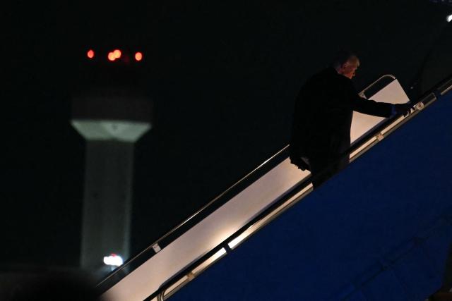 US President Donald Trump boards Air Force One as he departs from Palm Beach International Airport in West Palm Beach, Florida, on January 11, 2026. Trump is returning to the White House after spending the weekend at his Mar-a-Lago estate. (Photo by ANDREW CABALLERO-REYNOLDS / AFP)