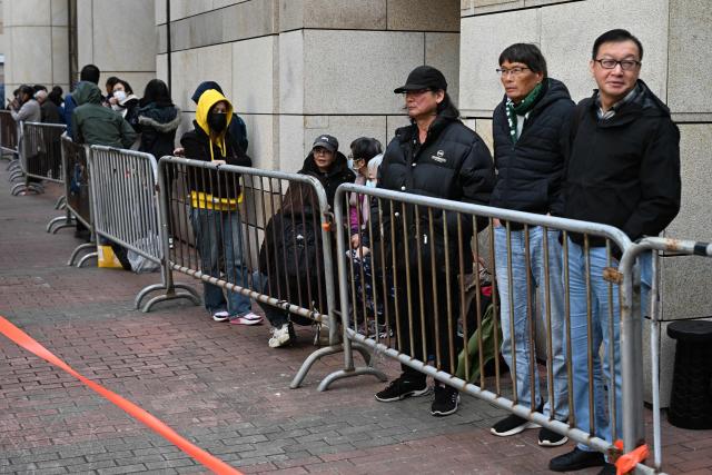 People queue outside the West Kowloon Magistrates' court in Hong Kong on January 12, 2026, for the sentencing arguments of convicted pro-democracy media tycoon Jimmy Lai. A Hong Kong court will hear sentencing arguments on January 12 for pro-democracy media tycoon Jimmy Lai, who was convicted of national security crimes that could land him in prison for life. (Photo by Peter PARKS / AFP)
