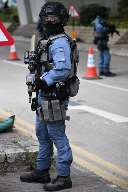 Armed police keep watch outside the West Kowloon Magistrates' court in Hong Kong on January 12, 2026, for the sentencing arguments of convicted pro-democracy media tycoon Jimmy Lai. A Hong Kong court will hear sentencing arguments on January 12 for pro-democracy media tycoon Jimmy Lai, who was convicted of national security crimes that could land him in prison for life. (Photo by Peter PARKS / AFP)