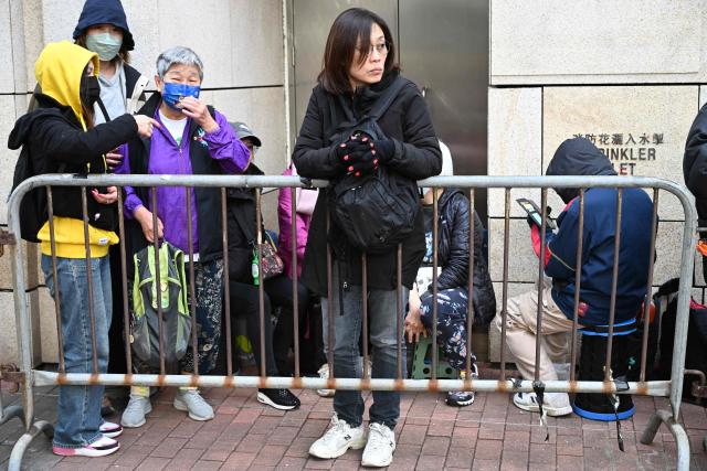 People queue outside the West Kowloon Magistrates' court in Hong Kong on January 12, 2026, for the sentencing arguments of convicted pro-democracy media tycoon Jimmy Lai. A Hong Kong court will hear sentencing arguments on January 12 for pro-democracy media tycoon Jimmy Lai, who was convicted of national security crimes that could land him in prison for life. (Photo by Peter PARKS / AFP)