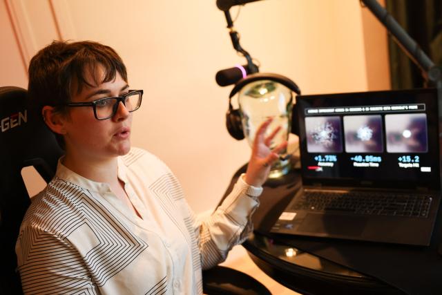 Neurable research scientist Dr. Alicia Howell-Munson speaks during an interview about Neurable and HP Inc.s HyperX collaboration brain-computer interface and gaming audio headset with the Prime application for neurofeedback to measure brainwave activity (EEG) and improve brain function during the annual Consumer Electronics Show (CES) in Las Vegas, Nevada on January 7, 2026. Beyond smart watches and rings, artificial intelligence is being used to make self-testing for major diseases more readily available, from headphones that detect early signs of Alzheimer's to an iris-scanning app that helps spot cancer. (Photo by Patrick T. Fallon / AFP)