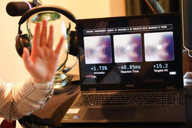 Neurable research scientist Dr. Alicia Howell-Munson speaks during an interview about Neurable and HP Inc.s HyperX collaboration brain-computer interface and gaming audio headset with the Prime application for neurofeedback to measure brainwave activity (EEG) and improve brain function during the annual Consumer Electronics Show (CES) in Las Vegas, Nevada on January 7, 2026. Beyond smart watches and rings, artificial intelligence is being used to make self-testing for major diseases more readily available, from headphones that detect early signs of Alzheimer's to an iris-scanning app that helps spot cancer. (Photo by Patrick T. Fallon / AFP)