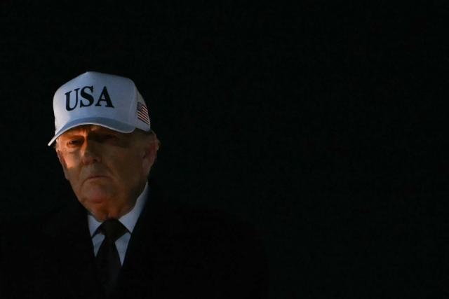 US President Donald Trump walks to board Marine One at Joint Base Andrews in Maryland on January 11, 2026. (Photo by ANDREW CABALLERO-REYNOLDS / AFP)