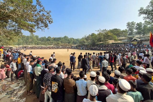 Rohingya refugees gather to play football at the Kutupalong refugee camp in Ukhia on January 10, 2026. In Bangladesh's sprawling Rohingya camps of Cox's Bazar, where more than a million refugees forced to flee Myanmar live in squalid conditions, hope is a fragile but persistent force. In rows of bamboo shelters and muddy lanes, refugees who escaped Myanmar nearly a decade ago await developments more than 8,000 kilometres (5,000 miles) away at the International Court of Justice (ICJ) in The Hague, where a genocide case against Myanmar opens on January 12. (Photo by MH Mustafa / AFP) / TO GO WITH 'Bangladesh-Myanmar-Gambia-ICJ-Rohingya-Genocide' REPORTAGE