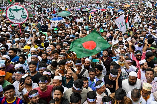(FILES) Jamaat-e-Islami party leaders and activists wave Bangladesh's national flag during a rally held to call for the introduction of a proportional representation system in the country's forthcoming general election and press other demands at the Suhrawardy Udyan in Dhaka on July 19, 2025. After years of repression, Bangladesh's Islamist groups are mobilising ahead of February 12, 2026 elections, determined to gain a foothold in government as they sense their biggest opportunity in decades. At the centre of this formidable push is Jamaat-e-Islami, the country's largest and best-organised Islamist party. (Photo by Munir UZ ZAMAN / AFP)