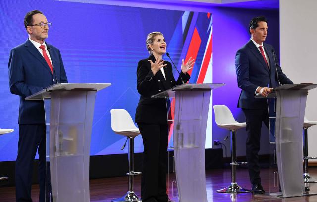 (L-R) Candidates for the Costa Rica's Presidential election Eliezer Feinzaig Mintz, of the Progressive Liberal Party, Laura Fernandez, of the Sovereign People Party and Jose Miguel Aguilar Berrocal, of the Avanza Party attend the debate at the Supreme Electoral Tribunal (TSE) in San Jose, Costa Rica on January 11, 2026. Costa Rica will hold presidential election on February 1. (Photo by Ezequiel BECERRA / AFP)