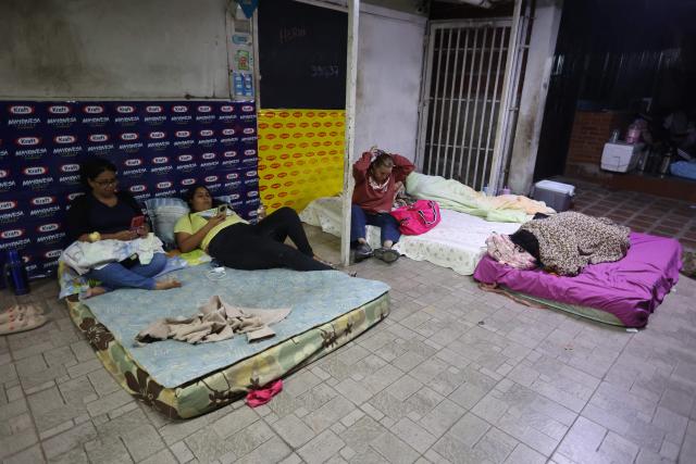 Relatives of political prisoners prepare to sleep in mattresses outside El Rodeo I prison in Guatire, Miranda State, some 30 kilometers east of Caracas on January 11, 2026. Venezuelans waited on January 11 for more political prisoners to be freed as ousted president Nicolas Maduro defiantly claimed from his US jail cell that he was "doing well" after being seized by US forces a week ago. (Photo by Pedro MATTEY / AFP)