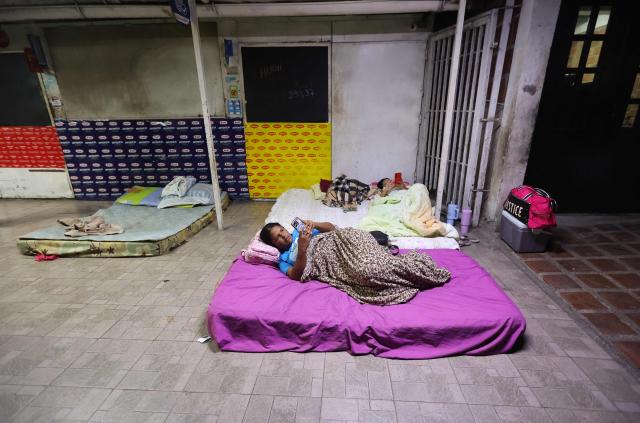 Relatives of political prisoners prepare to sleep in mattresses outside El Rodeo I prison in Guatire, Miranda State, some 30 kilometers east of Caracas on January 11, 2026. Venezuelans waited on January 11 for more political prisoners to be freed as ousted president Nicolas Maduro defiantly claimed from his US jail cell that he was "doing well" after being seized by US forces a week ago. (Photo by Pedro MATTEY / AFP)