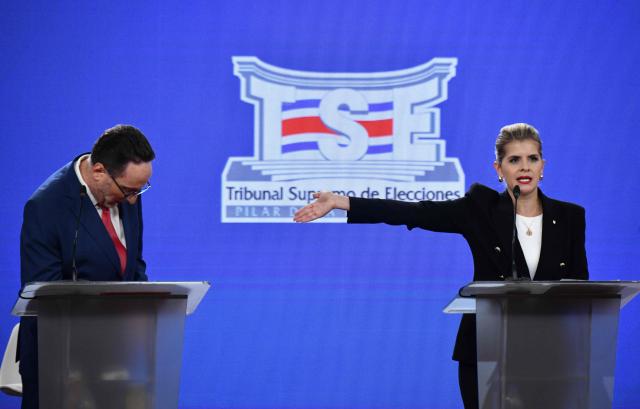 Costa Rica's Presidential candidate Eliezer Feinzaig Mintz, of the Progressive Liberal Party, listens to candidate Laura Fernandez, of the Sovereign People Party during the debate at the Supreme Electoral Tribunal (TSE) in San Jose, Costa Rica on January 11, 2026. Costa Rica will hold presidential election on February 1. (Photo by Ezequiel BECERRA / AFP)