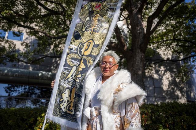 Construction worker Kenryu Sawada poses for photographs before attending a ceremony at Todoroki Arena to mark "Coming of Age Day" to honour people who turn 20 this year to signify adulthood, in Kawasaki, Kanagawa prefecture on January 12, 2026. (Photo by Yuichi YAMAZAKI / AFP)