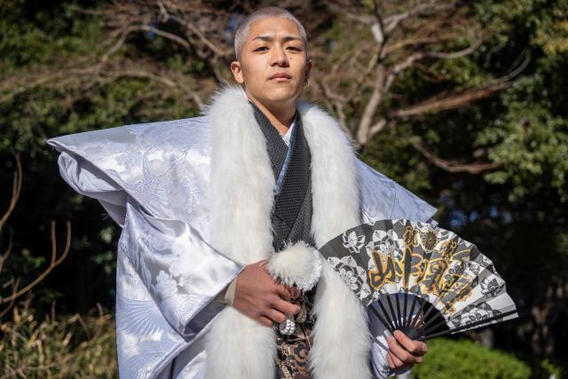 College student Kosei Yamanaka poses for photographs before attending a ceremony at Todoroki Arena to mark "Coming of Age Day" to honour people who turn 20 this year to signify adulthood, in Kawasaki, Kanagawa prefecture on January 12, 2026. (Photo by Yuichi YAMAZAKI / AFP)