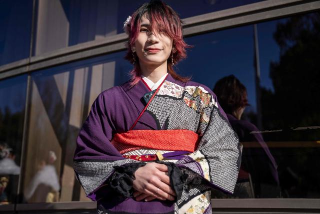 College student Yuki Kumagai poses for photographs before attending a ceremony at Todoroki Arena to mark "Coming of Age Day" to honour people who turn 20 this year to signify adulthood, in Kawasaki, Kanagawa prefecture on January 12, 2026. (Photo by Yuichi YAMAZAKI / AFP)