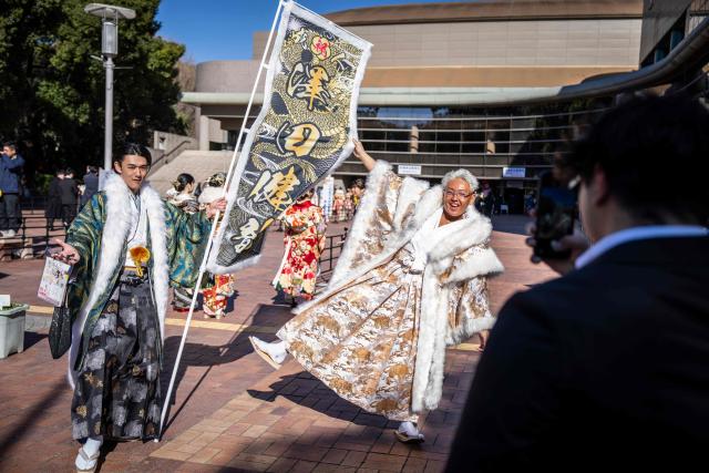 Men dressed in hakama pose for a photo as they arrive to attend a ceremony at Todoroki Arena to mark "Coming of Age Day" to honour people who turn 20 this year to signify adulthood, in Kawasaki, Kanagawa prefecture on January 12, 2026. (Photo by Yuichi YAMAZAKI / AFP)