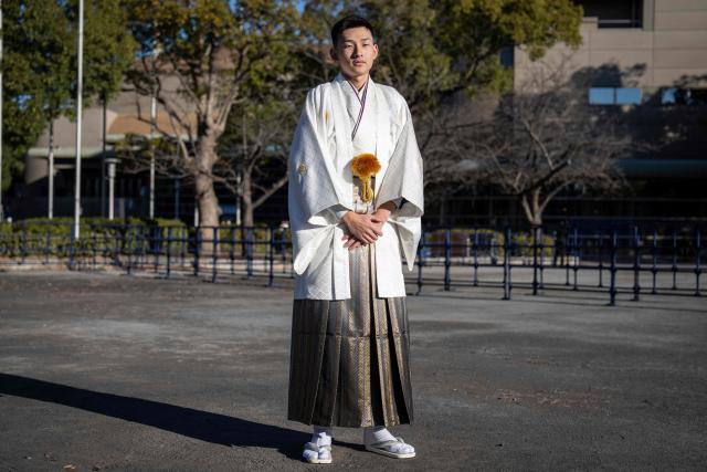 Technical school student Ninto Wakimura poses for photographs before attending a ceremony at Todoroki Arena to mark "Coming of Age Day" to honour people who turn 20 this year to signify adulthood, in Kawasaki, Kanagawa prefecture on January 12, 2026. (Photo by Yuichi YAMAZAKI / AFP)
