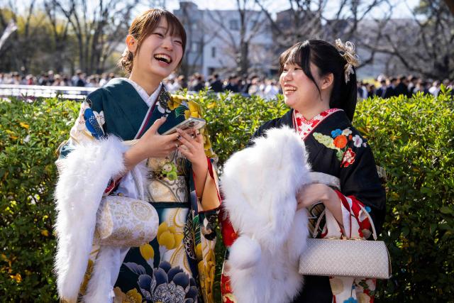 Women dressed in kimonos chat as they arrive to attend a ceremony at Todoroki Arena to mark "Coming of Age Day" to honour people who turn 20 this year to signify adulthood, in Kawasaki, Kanagawa prefecture on January 12, 2026. (Photo by Yuichi YAMAZAKI / AFP)