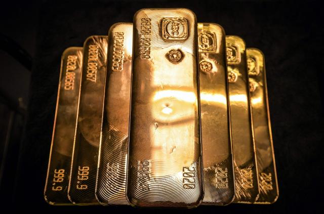 (FILES) Gold bullion bars are pictured after being inspected and polished at the ABC Refinery in Sydney on August 5, 2020. Gold and silver surged to record highs after the US Justice Department targeted the Federal Reserve in an investigation, fuelling fears over the bank's independence and raising demand for safe haven assets. (Photo by DAVID GRAY / AFP)
