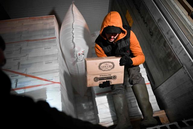 A farmer inspects transport of foreign products in a truck, as part of national protests against the EU-Mercosur agreement and the government's handling of the contagious nodular dermatitis (CND) epidemic, on the harbour of Le Havre, northwestern France on January 12, 2026. (Photo by Lou BENOIST / AFP)