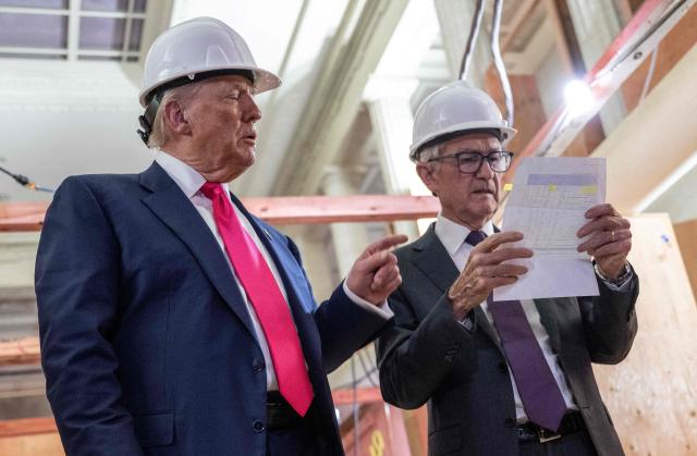 (FILES) US President Donald Trump points to a cost sheet as he speaks with Federal Reserve chair Jerome Powell (R) as he visits the Federal Reserve in Washington, DC, on July 24, 2025. Federal Reserve Chairman Jerome Powell said on January 11, 2026 that the central bank had been subpoenaed by the US Justice Department, blasting the move as part of President Donald Trump's extraordinary pressure campaign on US monetary policy decisions. (Photo by ANDREW CABALLERO-REYNOLDS / AFP)