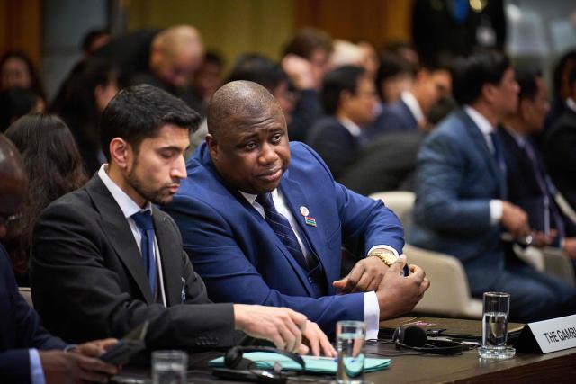 Dawda Jallow (C), Minister of Justice of the Republic of Gambia waits for the start of the first hearing at the International Court of Justice in which Myanmar is accused of committing genocide against the country's Muslim minority, the Rohingya, in the Hague on January 12, 2026. The Gambia filed the genocide case in cooperation with the Organization of Islamic Cooperation in 2019. Myanmar's military deliberately targeted the Rohingya minority in a bid to destroy the community, Gambia's Justice Minister Dawda Jallow told the International Court of Justice Monday at the start of a genocide hearing. (Photo by Phil Nijhuis / ANP / AFP) / Netherlands OUT