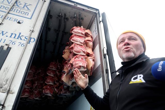 A French farmer of the agricultural union Coordination Rurale (CR) talks to journalists during a blockade at the exit of a toll booth on the A1 motorway near Fresnes-lès-Montauban, northern France, on January 12, 2026, as part of national protests against the EU-Mercosur agreement and the government's handling of the contagious nodular dermatitis (CND) epidemic. (Photo by Francois LO PRESTI / AFP)