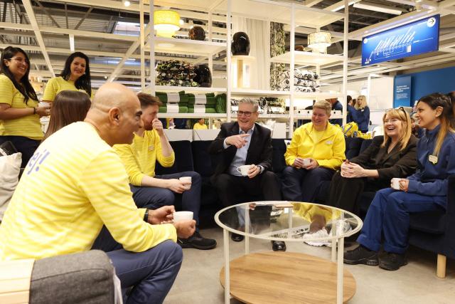 Britain's Prime Minister Keir Starmer (C) speaks with members of staff during a visit to a branch of Swedish furniture store Ikea in Croydon, south London on January 12, 2026. (Photo by Ian Vogler / POOL / AFP)