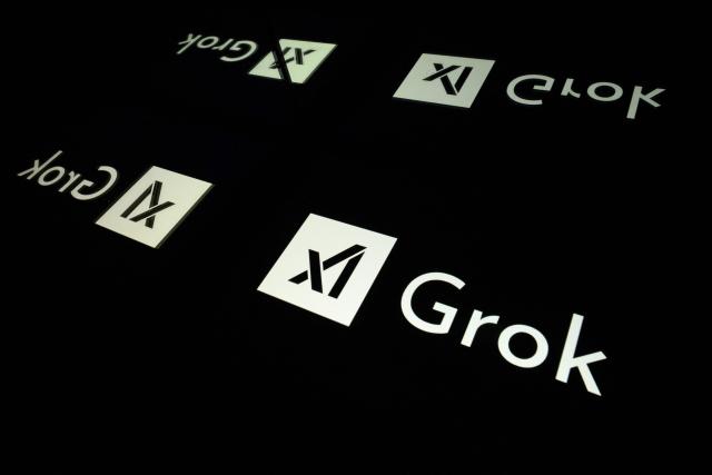 (FILES) This photograph shows screens displaying the logo of Grok, a generative artificial intelligence chatbot developed by US artificial intelligence company xAI, in Toulouse, southern France, on January 15, 2025. The UK's internet security regulator Ofcom announced on Monday, January 12, 2026, the opening of a "formal investigation" into the social network X "concerning sexually explicit images disseminated" by its artificial intelligence assistant Grok, according to a statement. (Photo by Lionel BONAVENTURE / AFP)